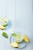 Pineapple and stinging nettle smoothies with coconut water and basil