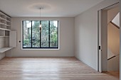 Empty minimalist interior with fitted cabinets, parquet floor and sliding door