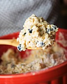 Blueberry scone dough on a wooden spoon