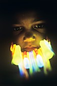 Boy's face lit by glow sticks