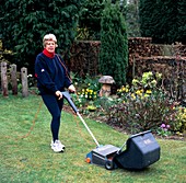 Woman mowing lawn