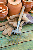 Hand fork and gardening gloves