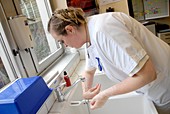 Nurse cleaning her hands