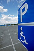 Disabled parking sign in empty car park