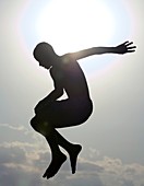 Silhouette of a boy jumping in the air