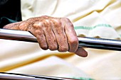 Hand of elderly patient in hospital bed