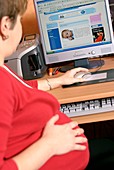 Pregnant woman reading a website