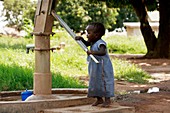 Young girl pumping water,Uganda