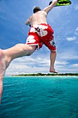 Man leaping into the sea