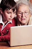 Elderly lady learning to use a laptop