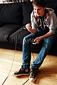 Teenager playing a video game