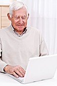 Elderly man using a laptop