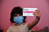 Child holds Swine Flu drug