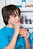Teenage boy drinking orange juice