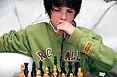 Teenager playing chess