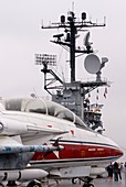 Armed military jet on aircraft carrier