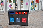 Recycling bins in front of fashion shop