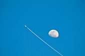 Day time moon and jet plane