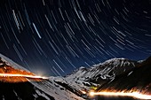Star trails over a mountain road,Iran