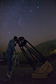 Observer using a Dobsonian telescope