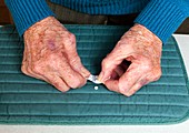 Elderly woman popping pills