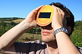 Man observing a solar eclipse