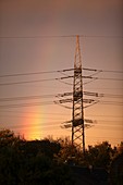 Rainbow and electricity pylon