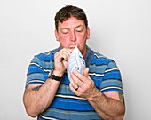 Man blowing into self-test breatlyser