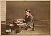 Photograph of woman making fans