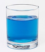 Glass filled with a blue liquid
