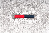 Bar magnet attracting metal filings