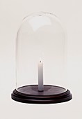 Lit candle in bell jar