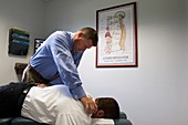 Chiropractor manipulating patient