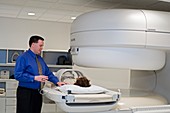 Chiropractor with patient and MRI scanner