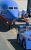 Ground crew directing jet airliner