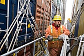 Port worker handling cargo containers