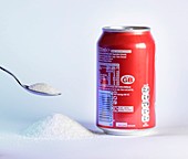 Teaspoon of sugar with can of fizzy drink