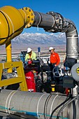 Workers inspecting water pumps