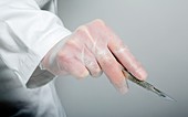 Doctor holding a scalpel