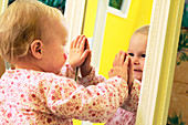 Toddler interacting with a mirror