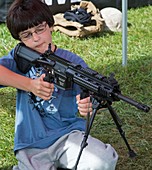 Boy with automatic rifle
