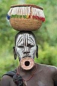 Mursi woman with lip plate and basket
