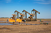 Gas flares and pumps at an oil field