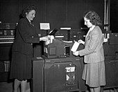 EINAC programmers with punch card machine