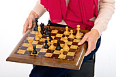 Woman holding chess board