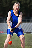 Elderly woman competitive weights thrower