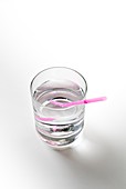 Glass of water with a straw