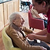 Elderly woman with carer