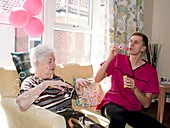 Care assistant with elderly woman