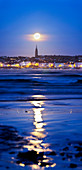 Full moon over coastal town